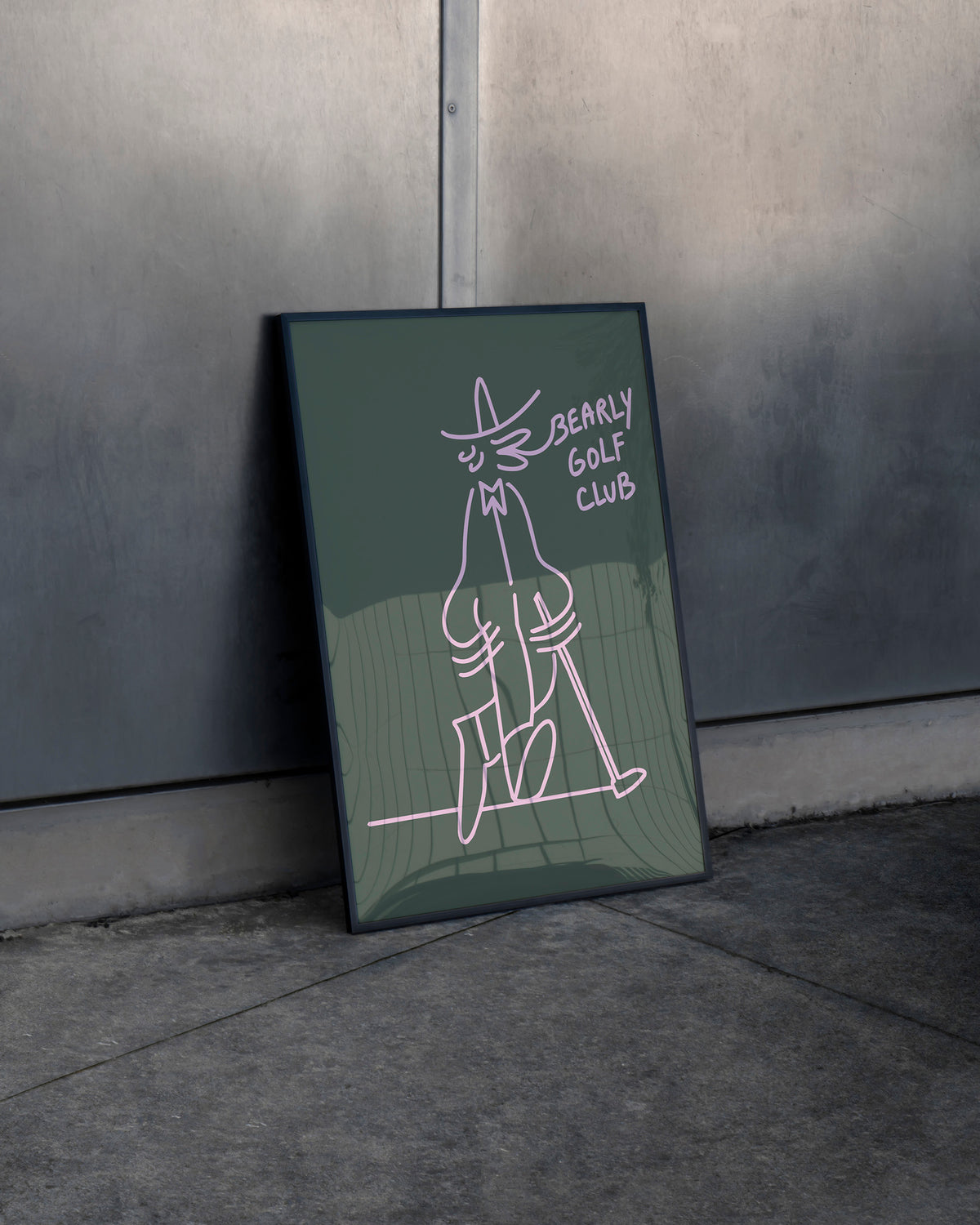 Framed dark green Gus Gus Golf Club art print leaning against a wall